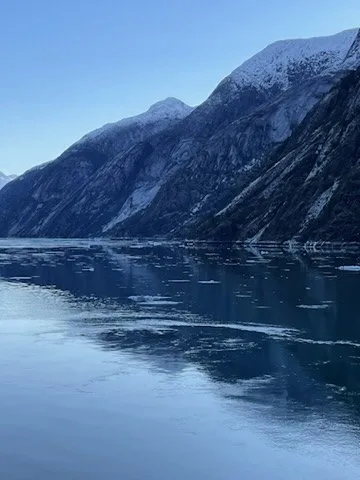 Snow-dusted mountains reflected in a calm passage — Alaska — Aurora Borealis and Inside Passage
