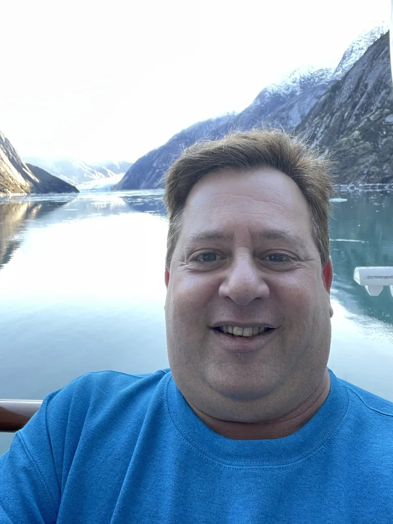 Scott smiling with the Alaska glacier passage behind him — Alaska — Aurora Borealis and Inside Passage