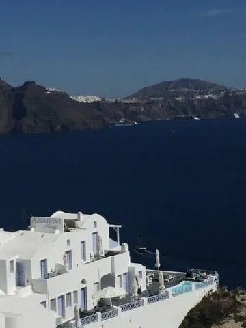 Caldera blue framed by white rooftops — Santorini — Oia
