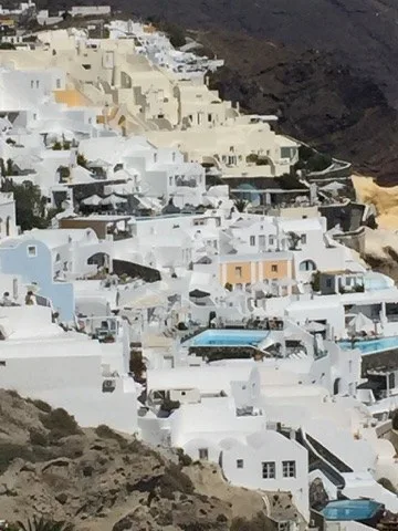 Layered white village above the caldera — Santorini — Oia
