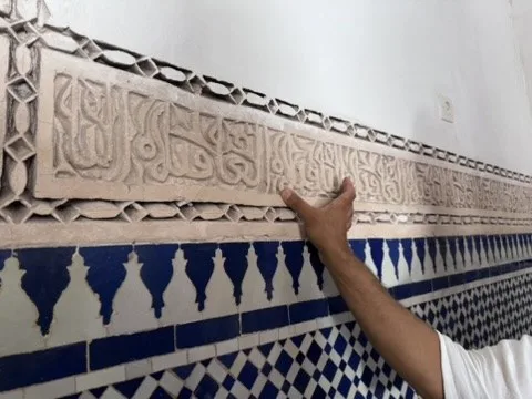 Carved inscription and zellige tilework — Marrakesh, Morocco