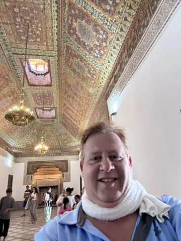 Scott beneath the carved cedar ceiling — Ben Youssef Madrasa