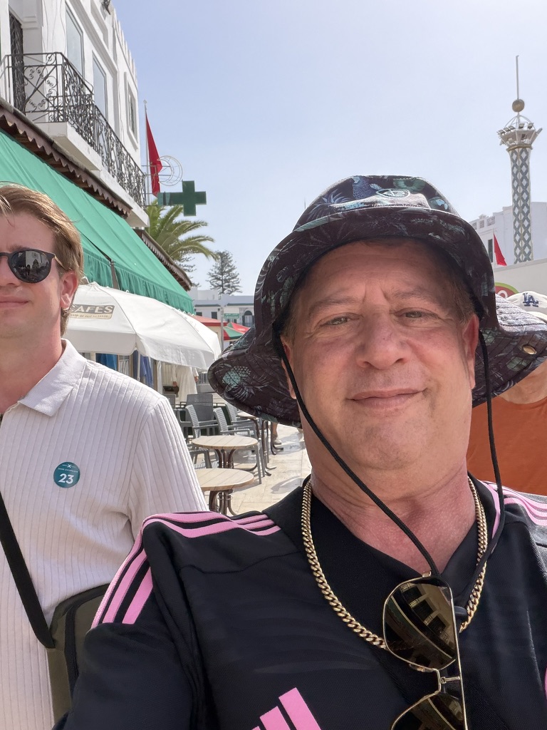 A day ashore begins: Scott A. Astin in an outdoor port walkway with another traveler partly visible beside him