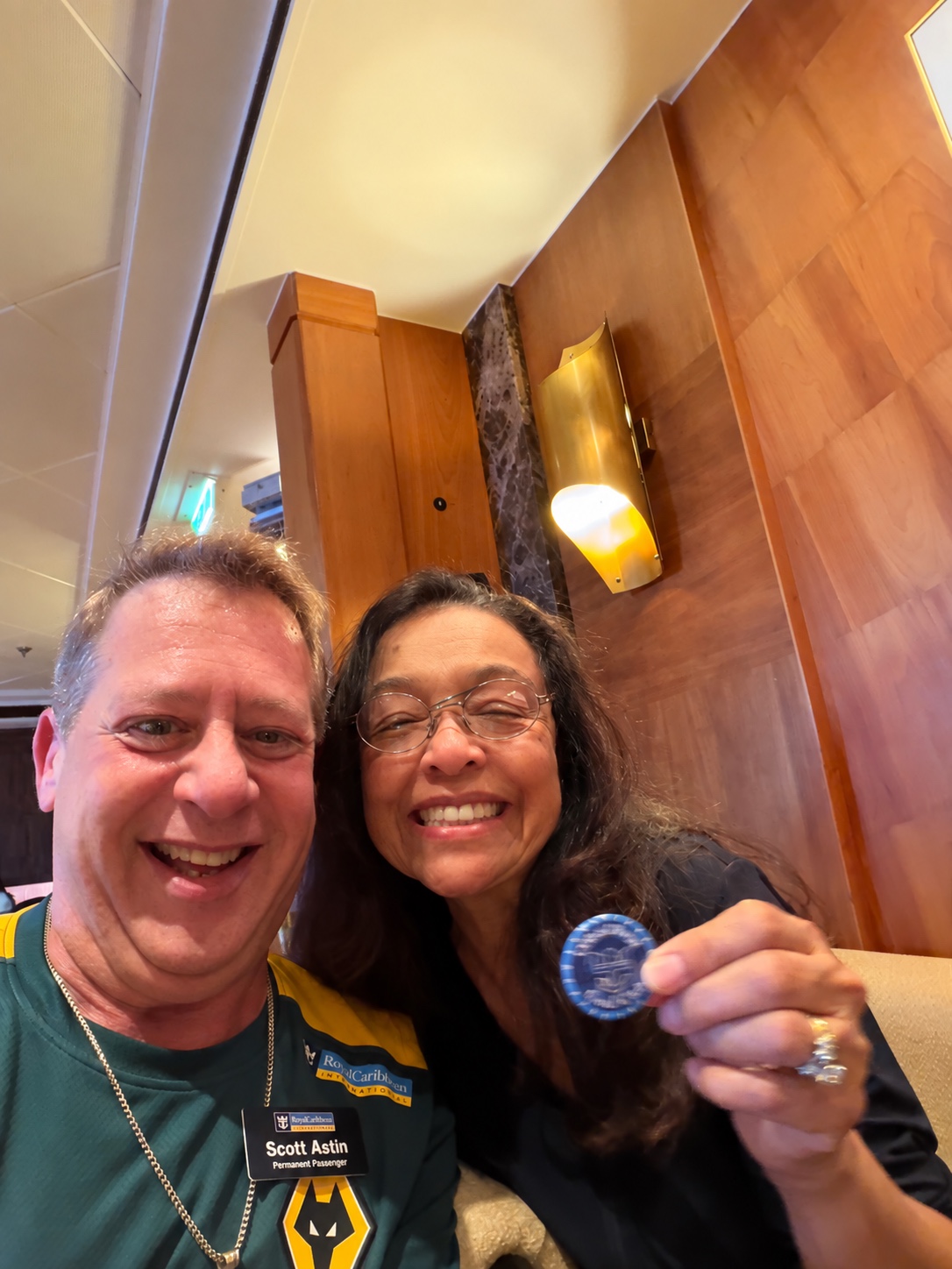 A little recognition among friends: Scott A. Astin seated with a fellow traveler displaying a blue keepsake pin