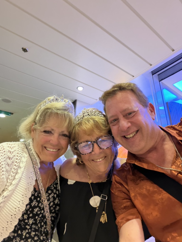 The people who turn a trip into a reunion: Scott A. Astin smiling with two fellow travelers aboard ship