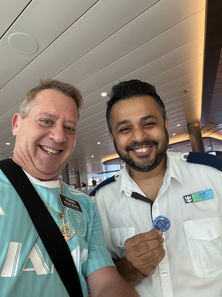 Service that feels personal: Scott A. Astin beside a uniformed crew member holding a blue keepsake pin