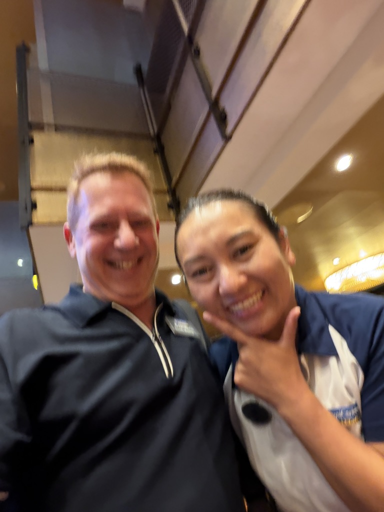 A quick photograph between the work: Scott A. Astin taking a close selfie with a uniformed crew member
