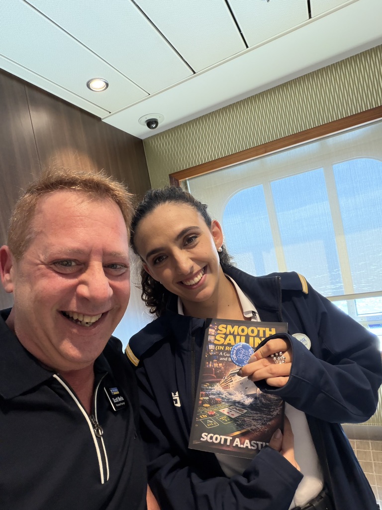 A book finds its way aboard: Scott A. Astin with a uniformed crew member holding a copy of Smooth Sailing in Rough Waters