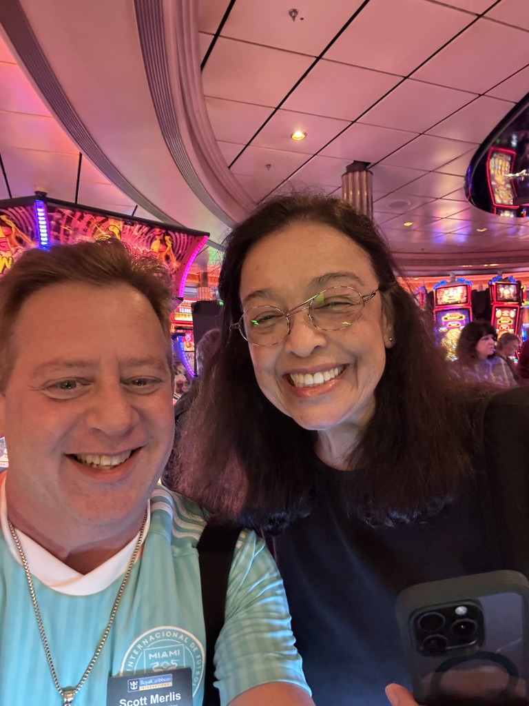 A familiar face in the casino glow: Scott A. Astin smiling with a fellow traveler in a casino