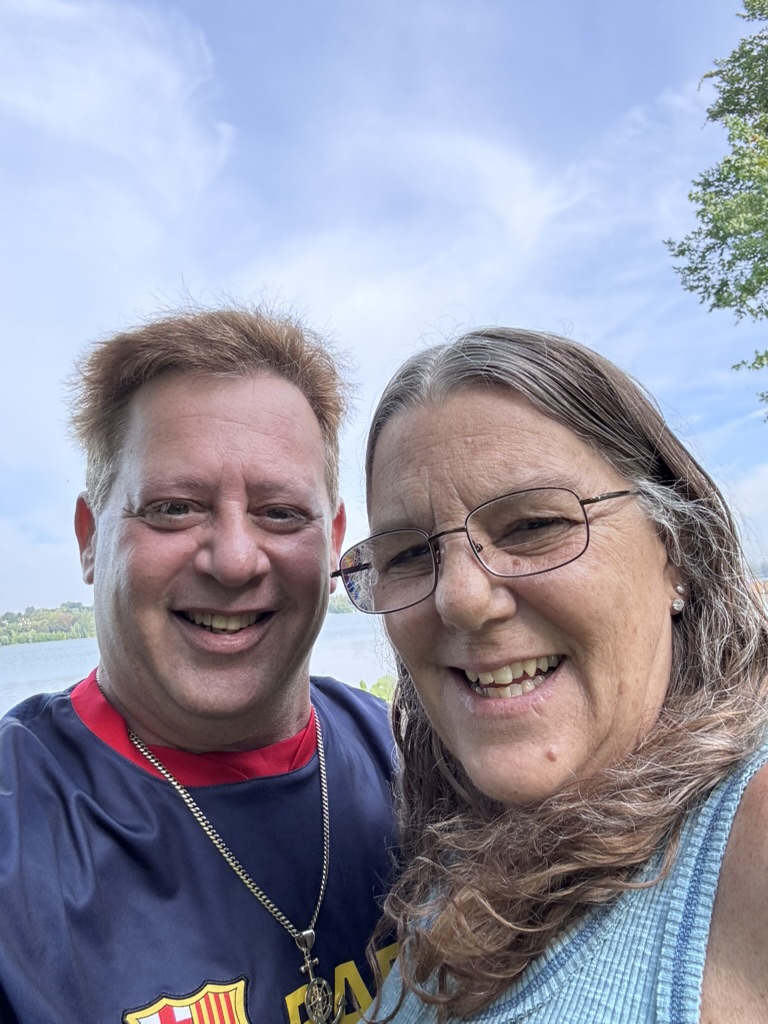 A friendship that traveled ashore: Scott A. Astin taking an outdoor waterfront selfie with a fellow traveler