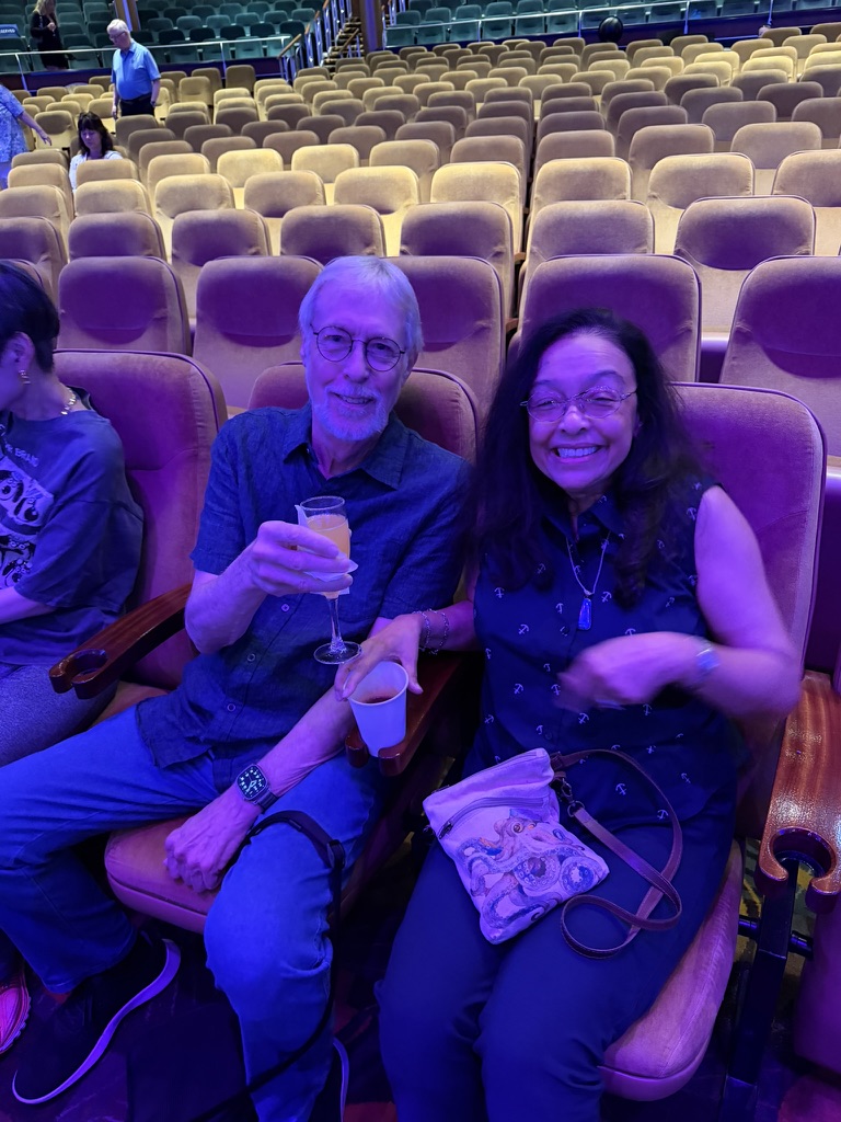 Two friends seated in the Navigator theater for Scott Astin’s Pinnacle ceremony