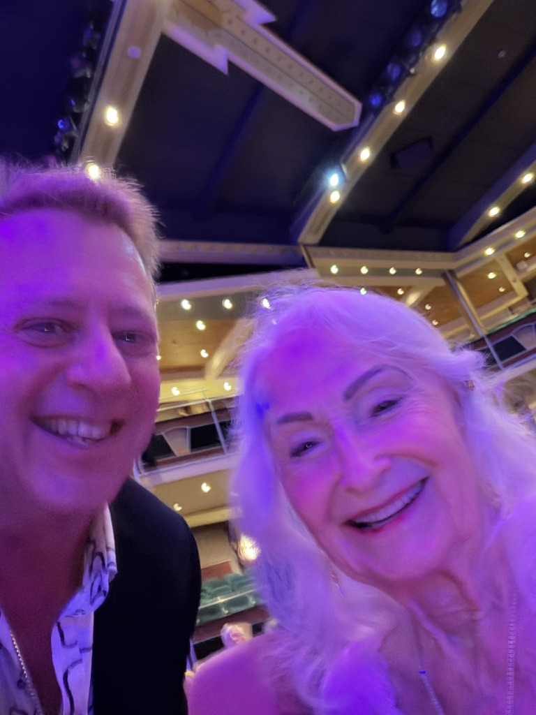 Scott Astin smiling with a friend in the Navigator theater